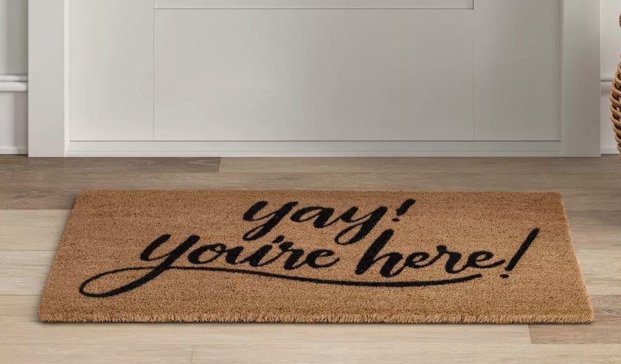 Brown doormat that says &quot;yay! you&#x27;re here&quot; in black writing