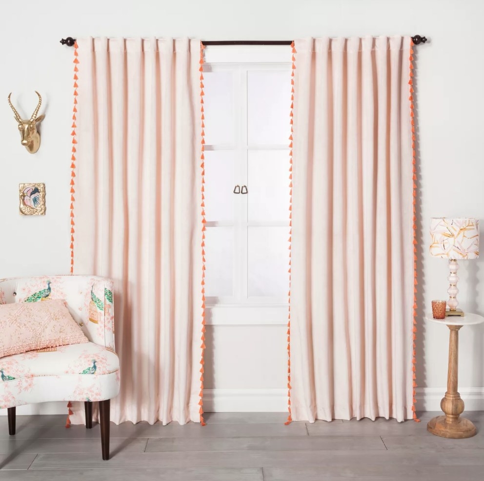 Pink velvet curtains with orange tassels