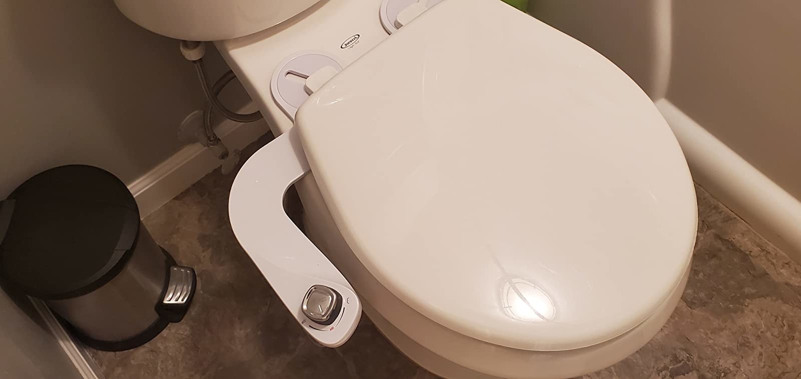 the white bidet attachment on a toilet