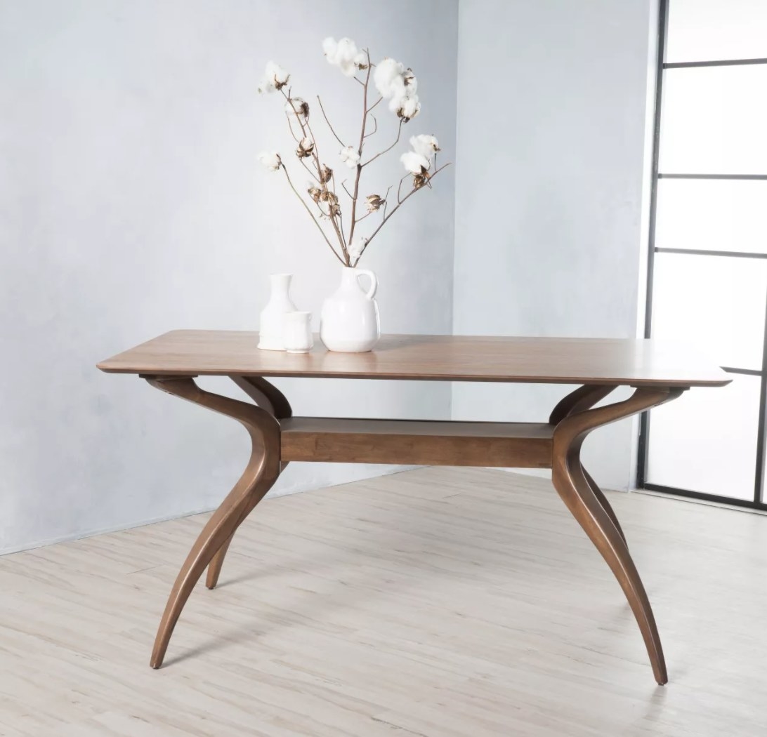 Wooden dining table with concave legs