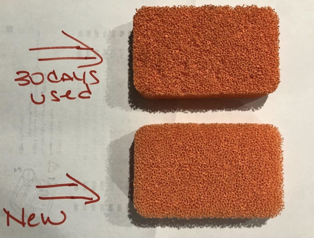 reviewer photo showing their sponge after 30 days of use compared to a new one, and they both look nearly the same