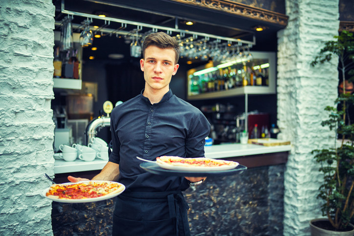 Server holding plates of food