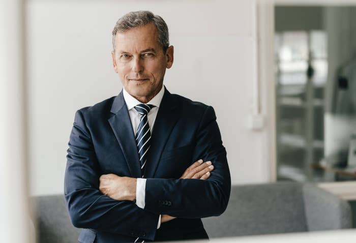 Wealthy man in a suit with his arms crossed