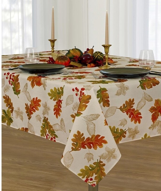 white table cloth with colorful fall leaves and berries