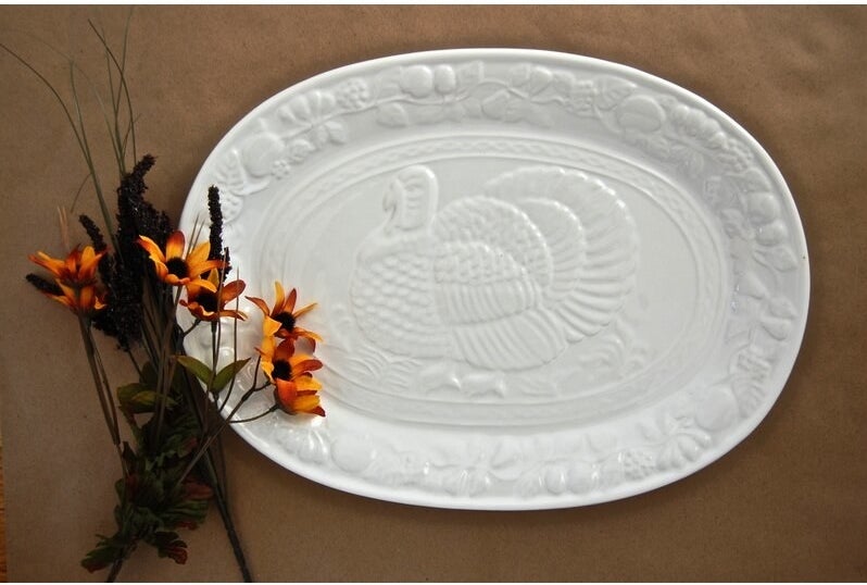 white oval platter with embossed turkey design