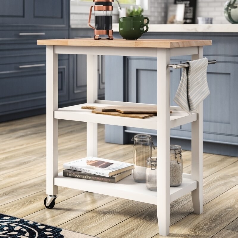 kitchen cart with wood top, two shelves, white legs, and wheels