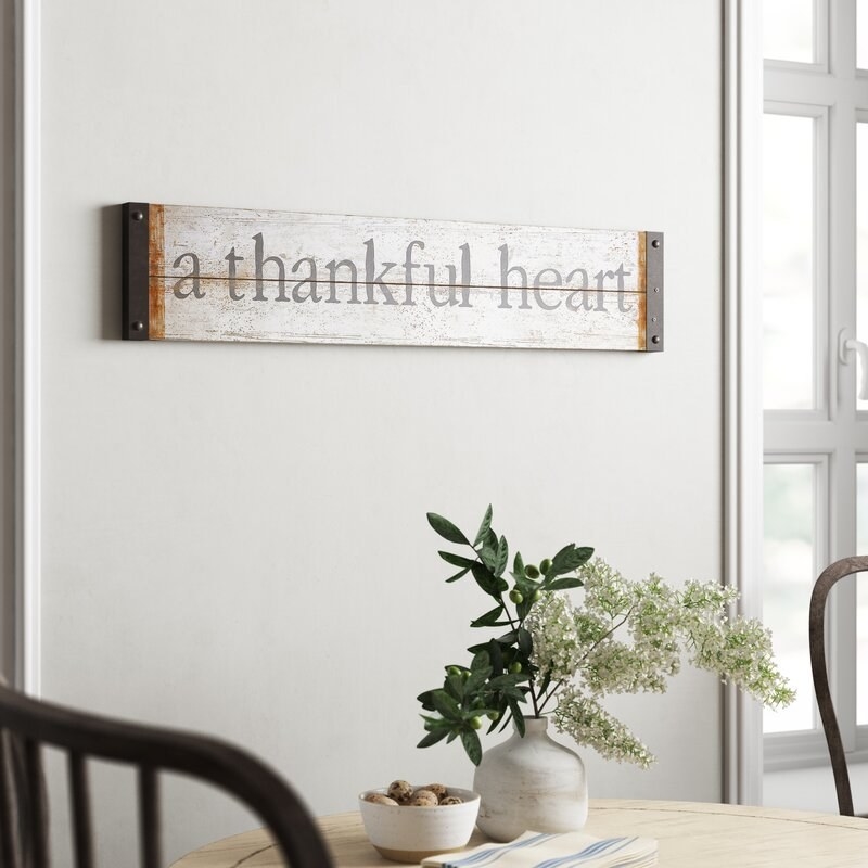 white distressed sign thank says &quot;a thankful heart&quot; hung on the wall