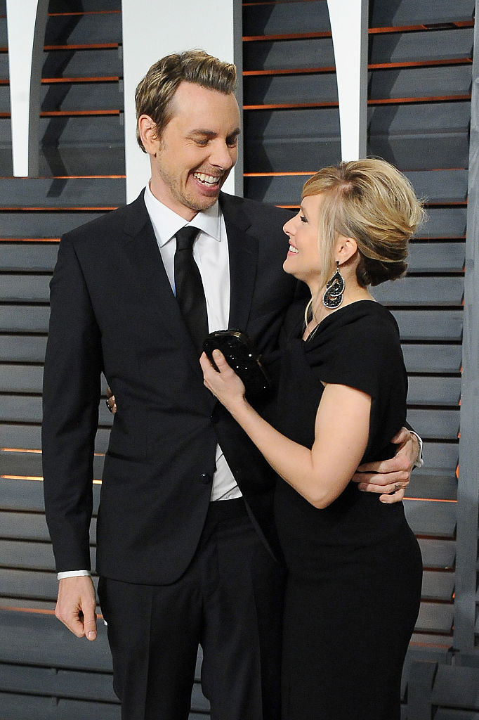 Dax Shepard (L) and Kristen Bell laugh together at the 2015 Vanity Fair Oscar Party hosted by Graydon Carter