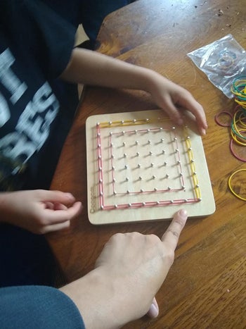 reviewer's photo of their child's red and yellow pattern created on the geoboard