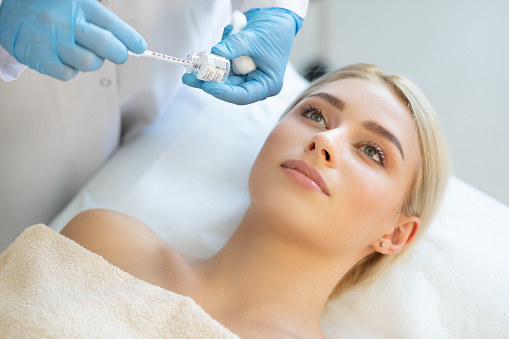 A dermatologist applying a treatment.