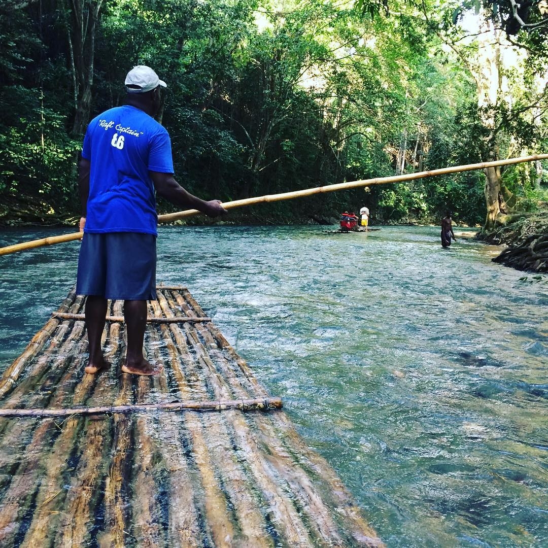 A man rafting on the Martha Brae River in Jamaica