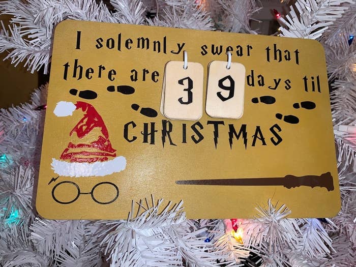 A wooden 8- by 10-inch board with the words &quot;I solemnly swear that there are 39 days til Christmas&quot; written on it with various Harry Potter imagery