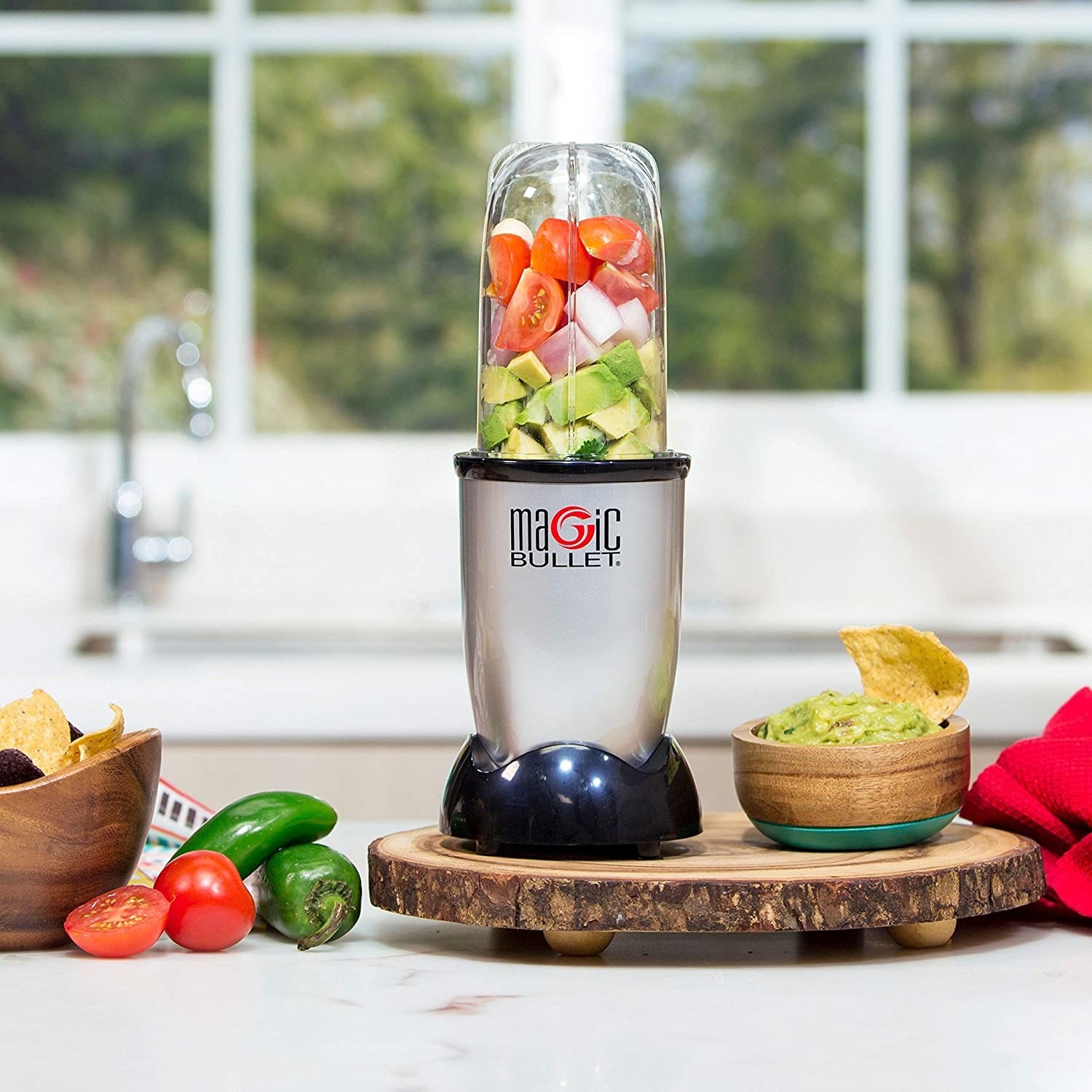 the magic bullet blender filled with all the ingredients to make guacamole