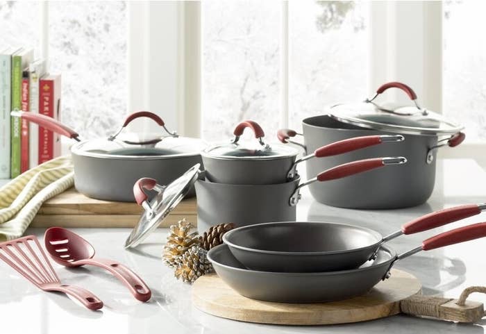 Rachael Ray cookware set styled on a counter with pots, pans, and lids