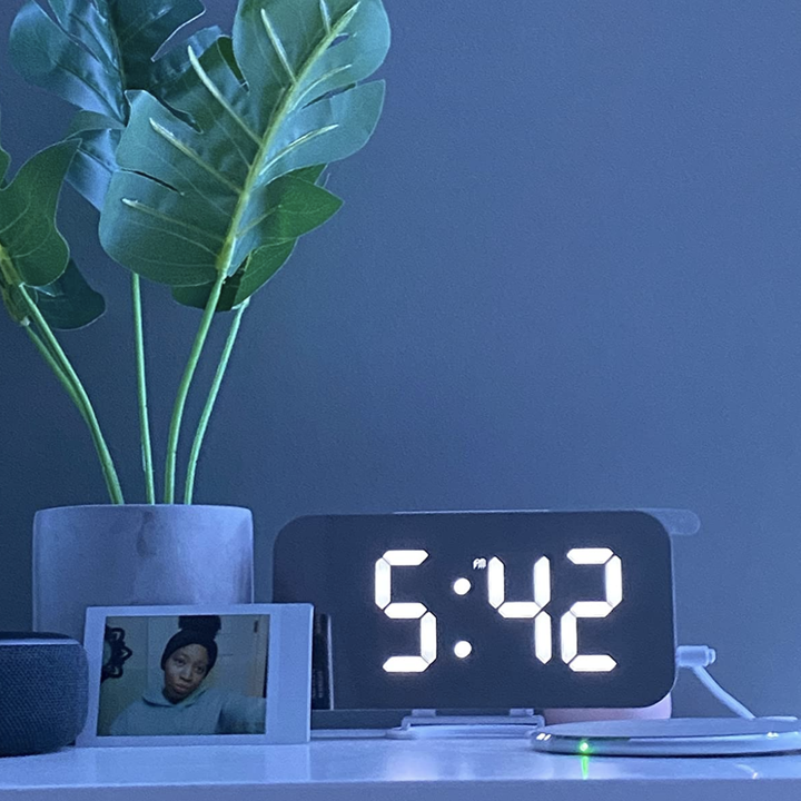 A reviewer's mirrored clock on their nightstand