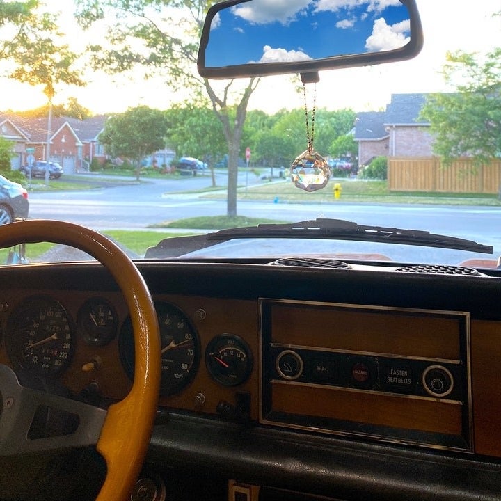 Crystal sun-catcher hanging from a rearview mirror