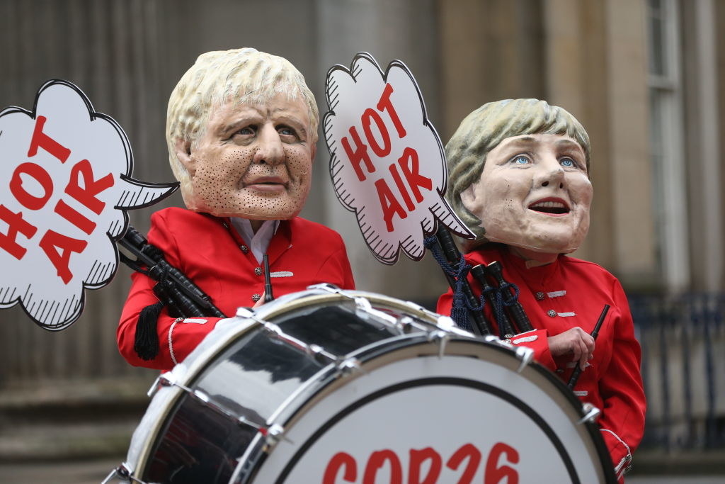 protesters holding signs that say &quot;Hot Air&quot;