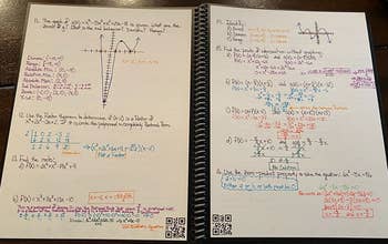 a reviewer photo of the open notebook filled with notes showing small QR codes in the bottom corner of each page
