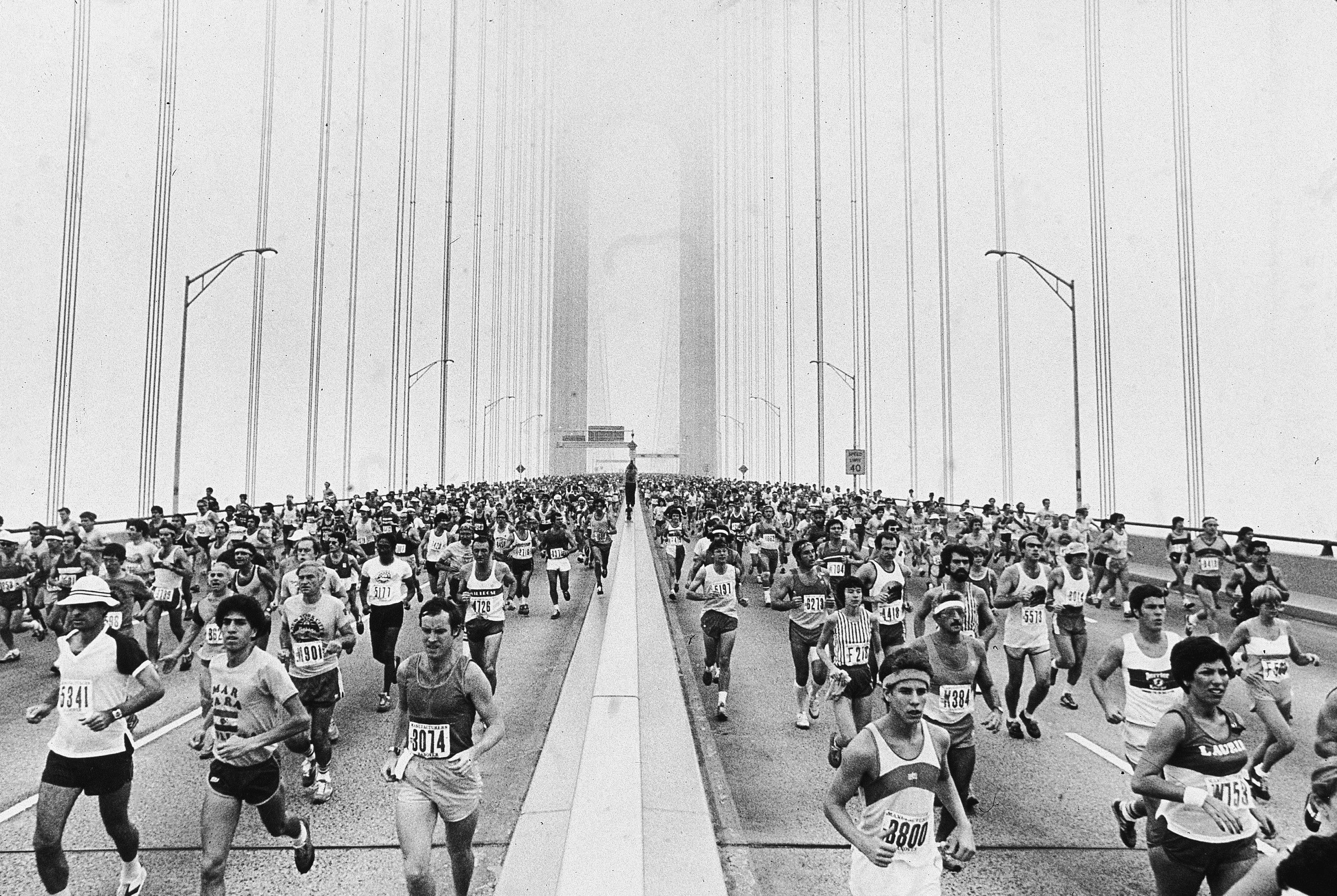 Wide black-and-white shot of runners