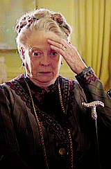 Maggie Smith scratching her forehead and looking really shocked
