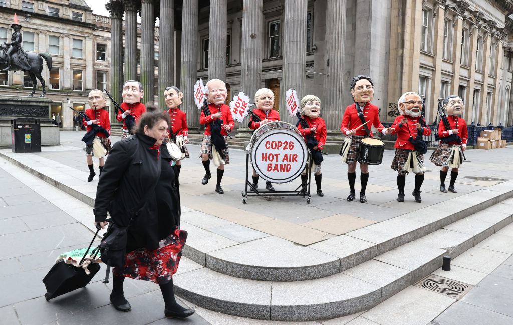 Protesters wearing masks of different world leaders