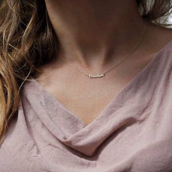 A model wearing the necklace with the Braden on it
