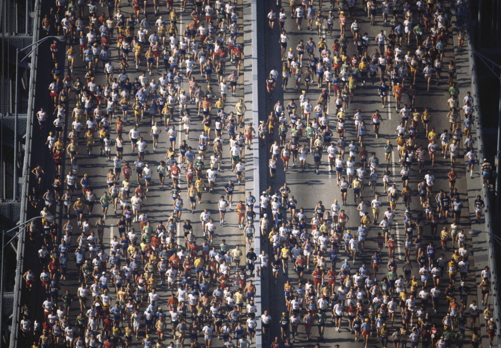 Many people running across the bridge seen from above