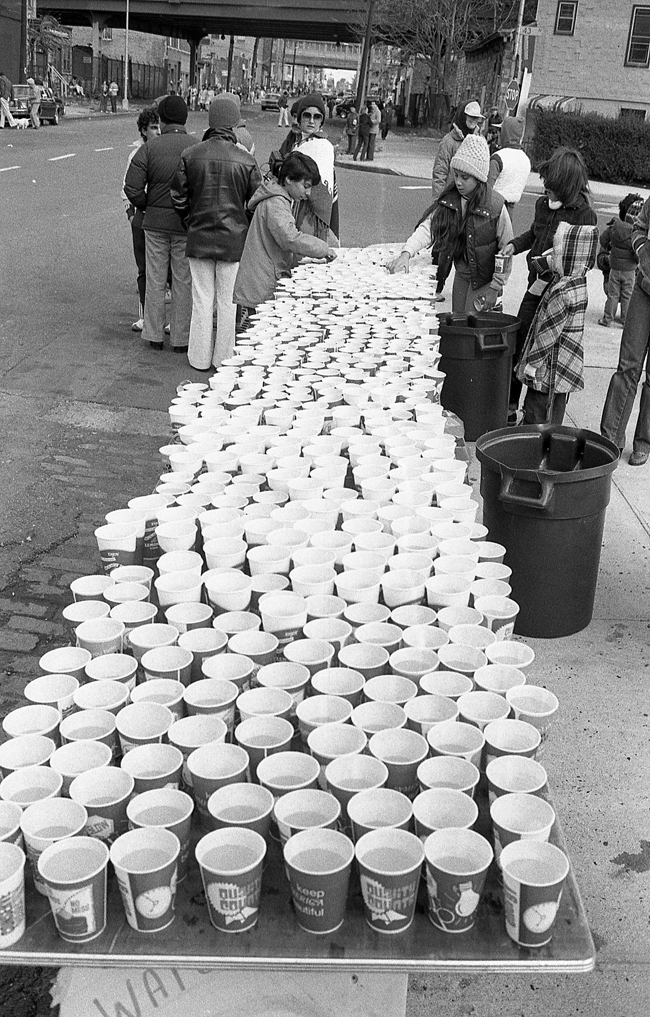 Hundreds of cups on a table in a black-and-white photo