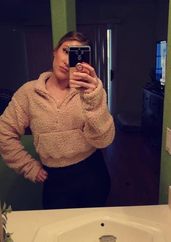 reviewer mirror selfie wearing brown cropped fuzzy hoodie