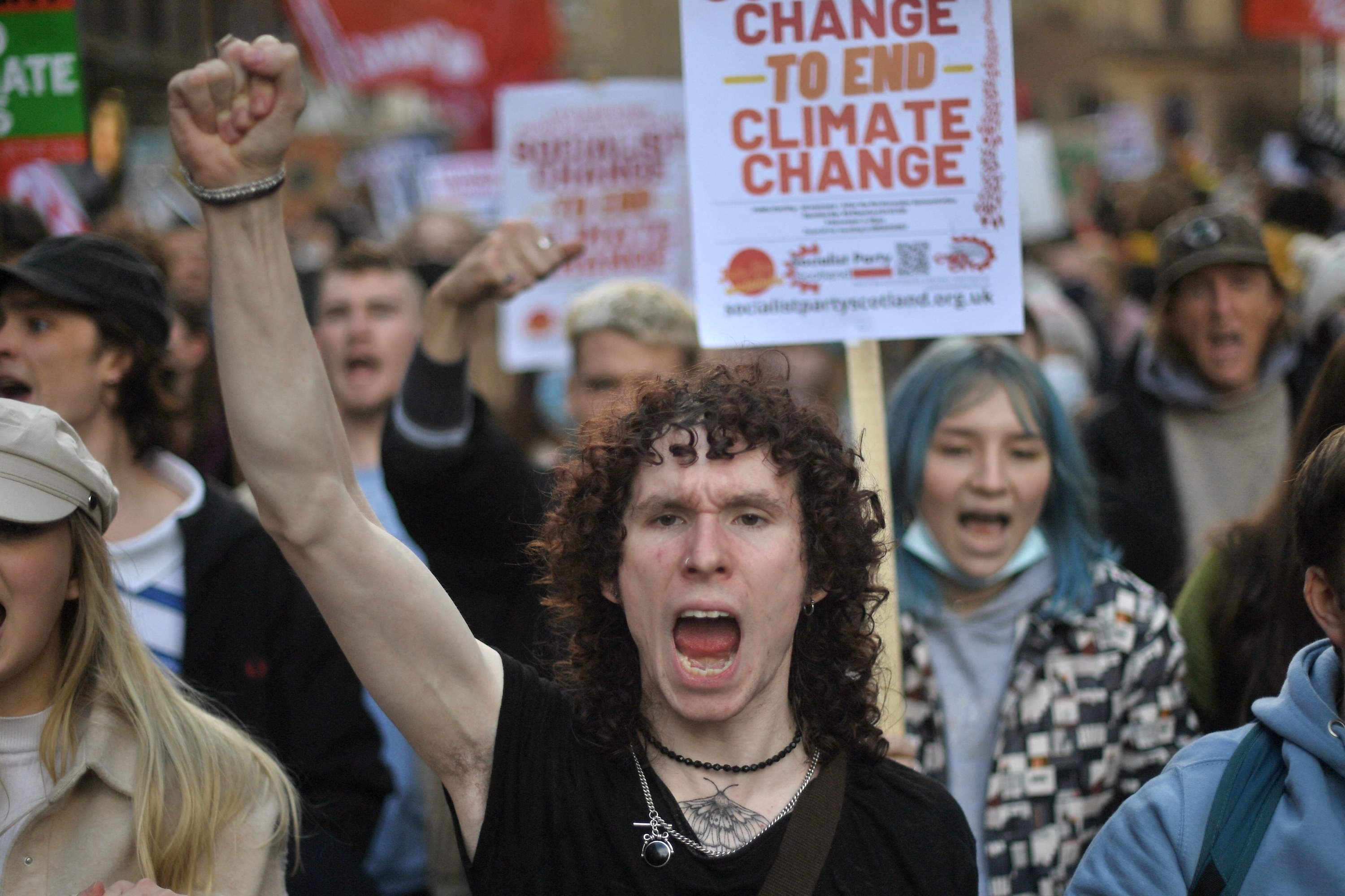 A person shouts and holds a fist in the air