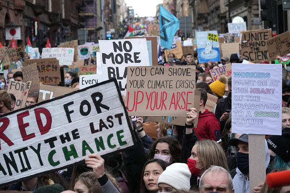 Various signs being held up at the protest