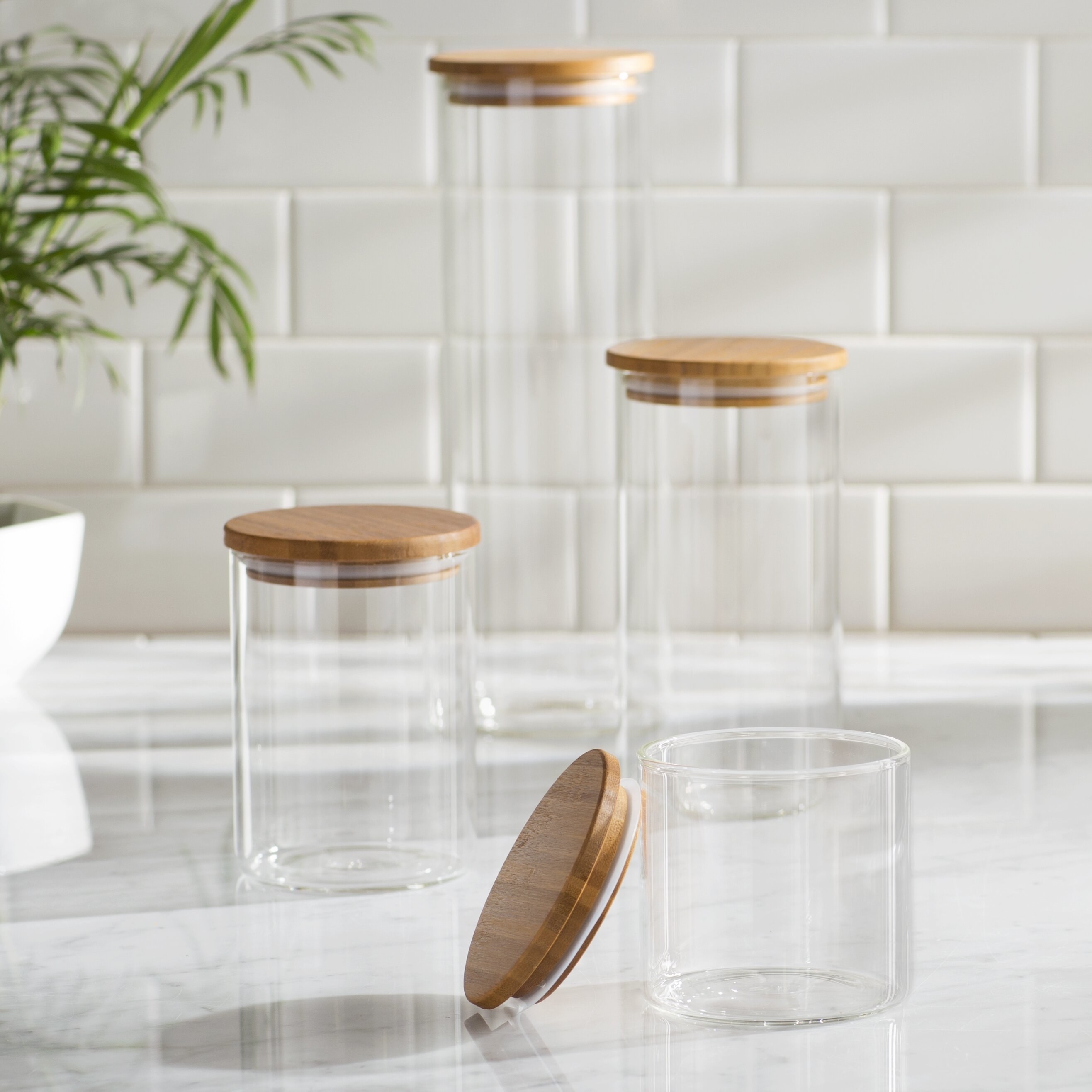 four glass jars with wooden top