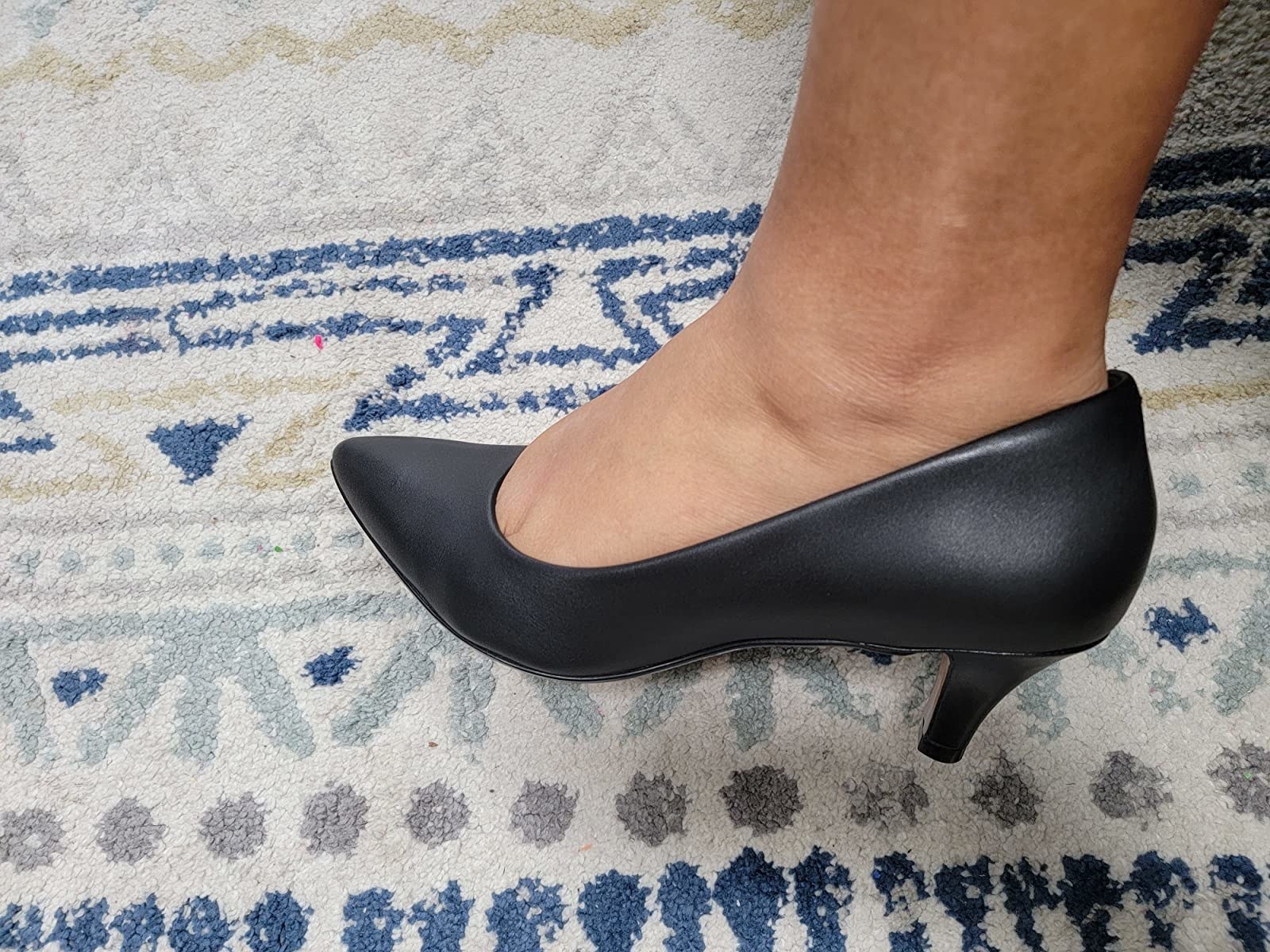 reviewer wearing pointed-tow low-heeled black pump