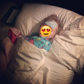 reviewer's photo of their child in bed wearing the gel sheet on their forehead