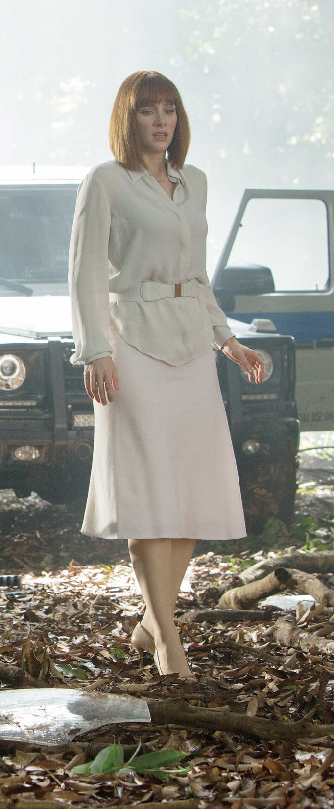 Claire stands in heels in the wreckage