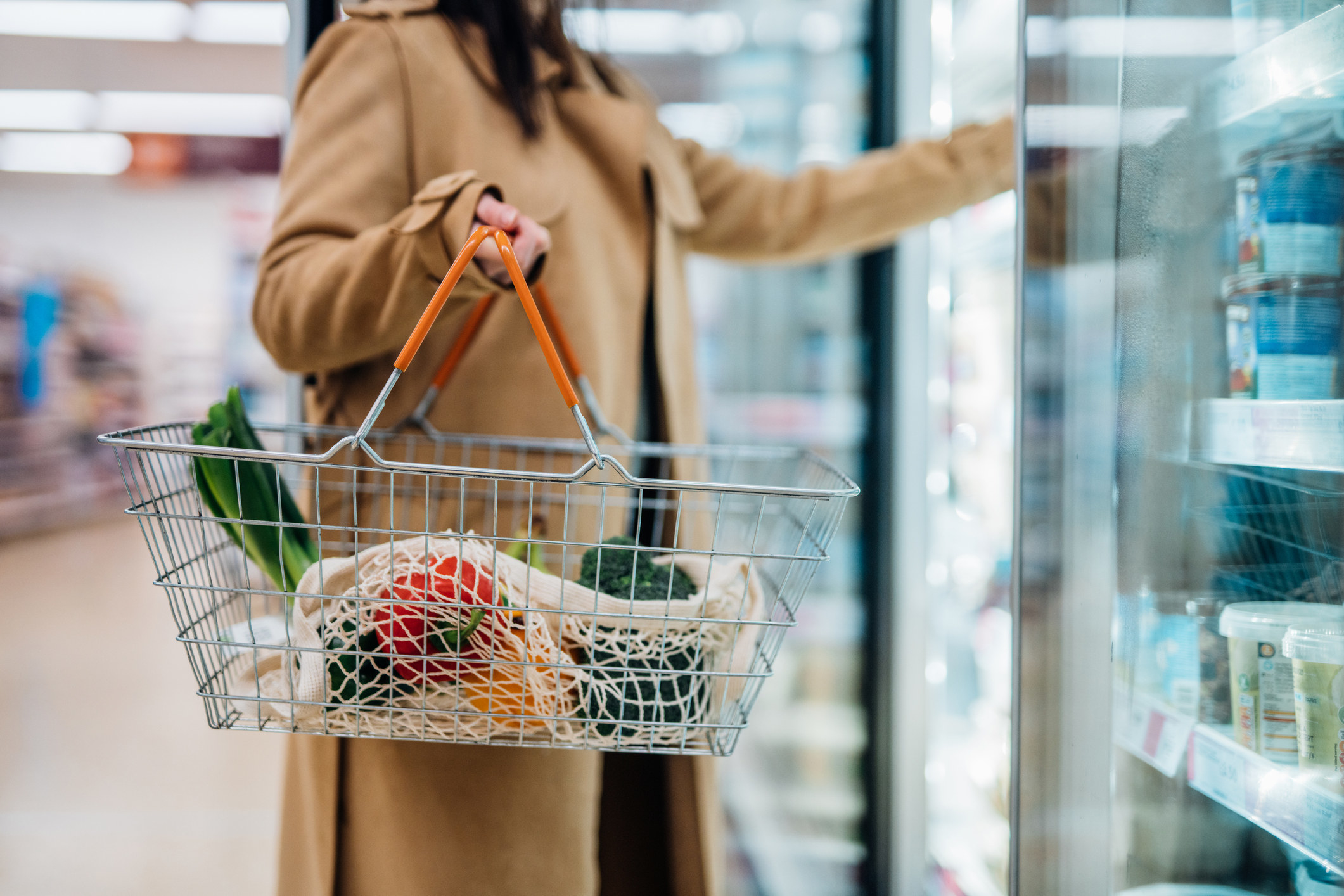 Person putting food items in a wire basket