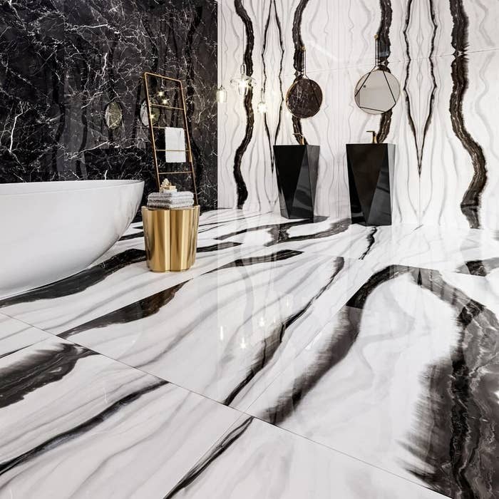 a bathroom covered in marbled tiles