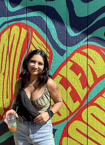 Reviewer wearing the black fanny pack as a crossbody bag