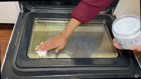 gif of hands getting dirty oven glass door clean with scrub