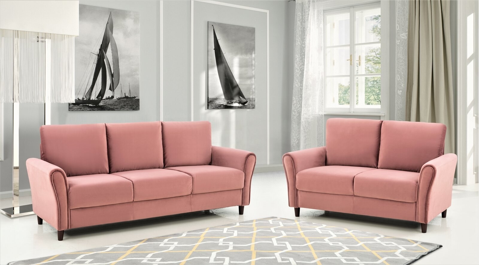 Two pink velvet couches around a gray, yellow, and white rug