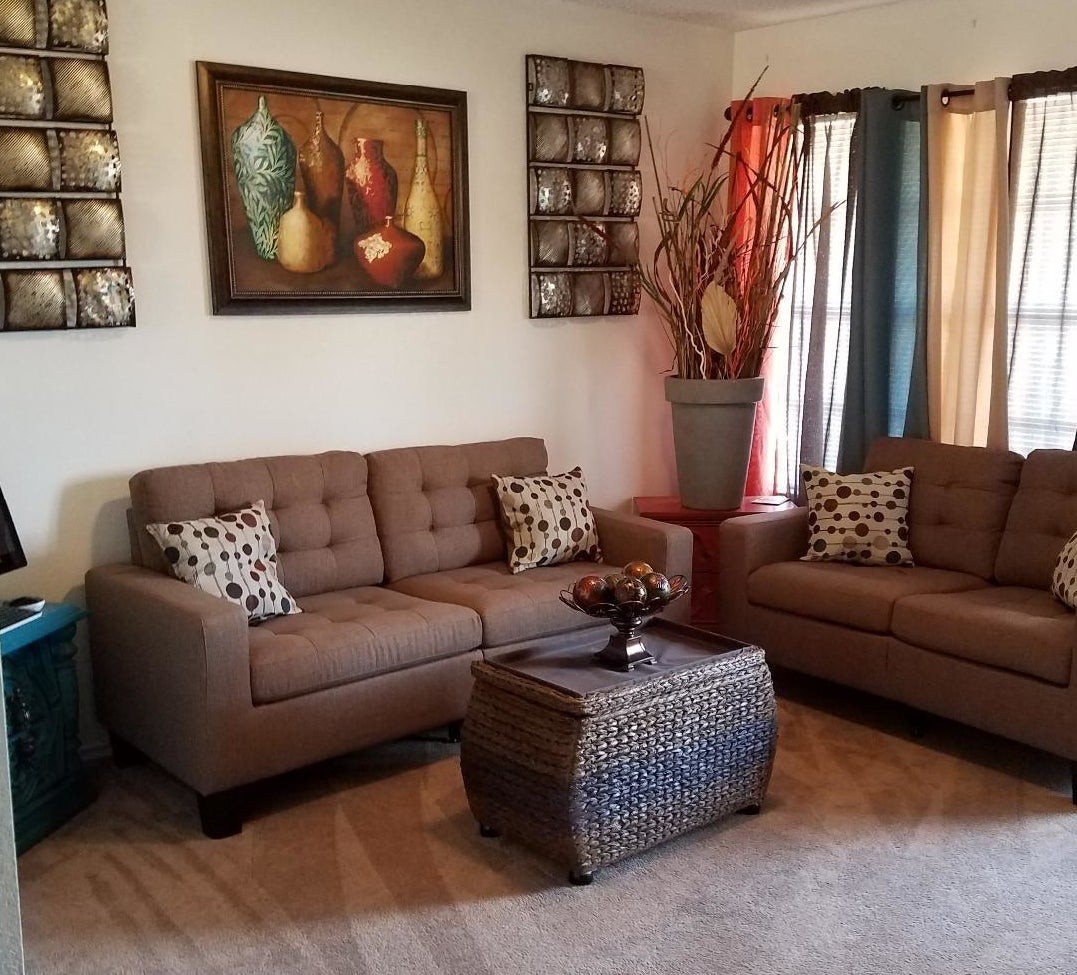 Reviewer photo with brown fabric couch and polka dot throw pillows