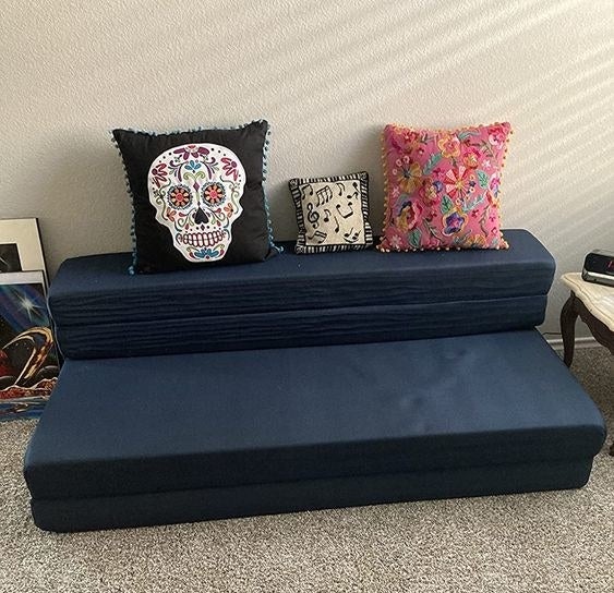 A navy blue futon in a reviewer&#x27;s home
