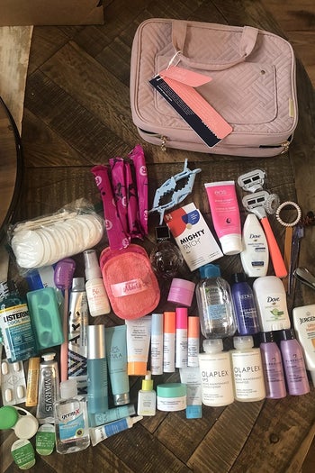 Reviewer photo of all of the toiletries they were able to fit in the case, next to the zipped-up bag