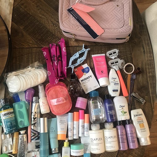 Reviewer photo of all of the toiletries they were able to fit in the case, next to the zipped-up bag