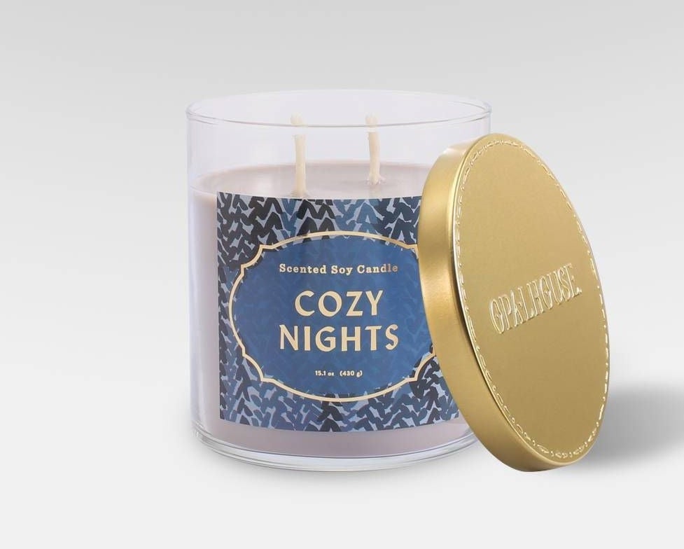 a cozy nights scented soy candle in a glass container with gold-tone lid