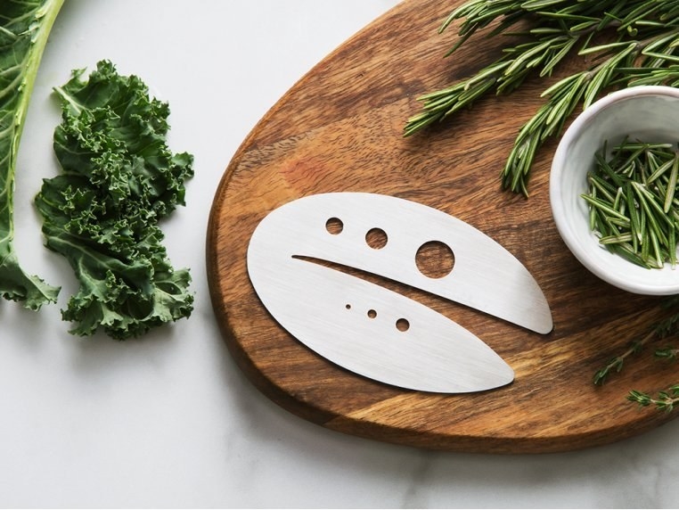 a product shot of the kale and herb stripping tool and you can see its design and the different holes used for different types of herbs