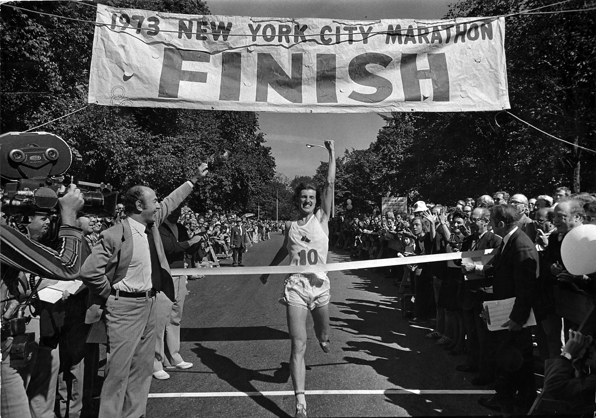 Fleming crosses the finish line as spectators look on