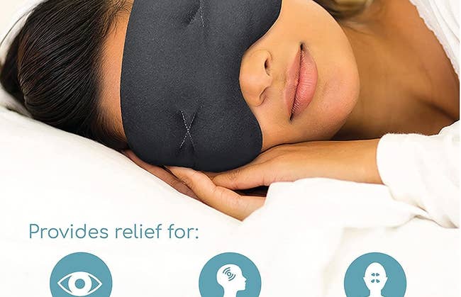 Model wears black mask over their eyes while curled up in bed