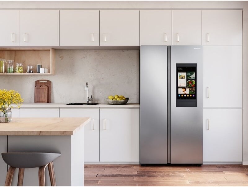 a kitchen with the smart stainless steel fridge with a large touchscreen on its righthand door