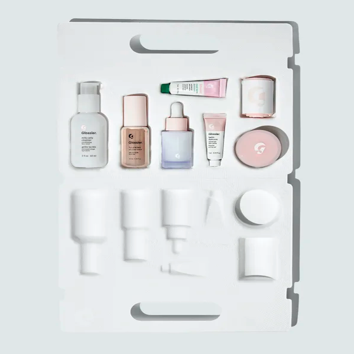the seven items in the skincare set sitting in its open carrying case.